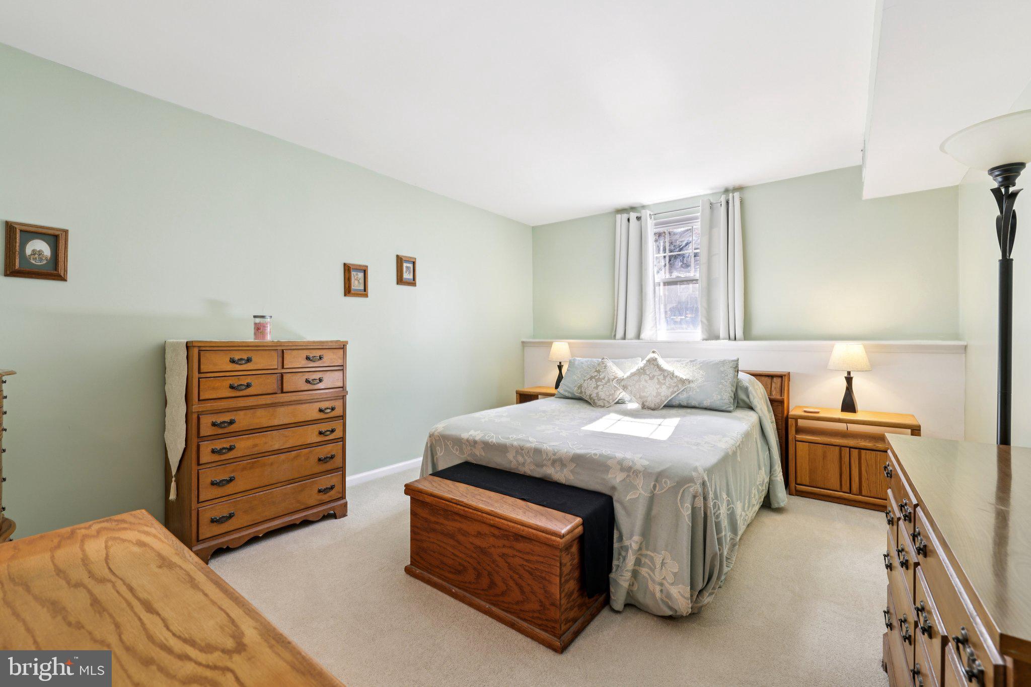 13 Pickering Court, Unit 1302 Germantown, MD 20874 - Photo 21 of 50 a bedroom with a bed and a dresser