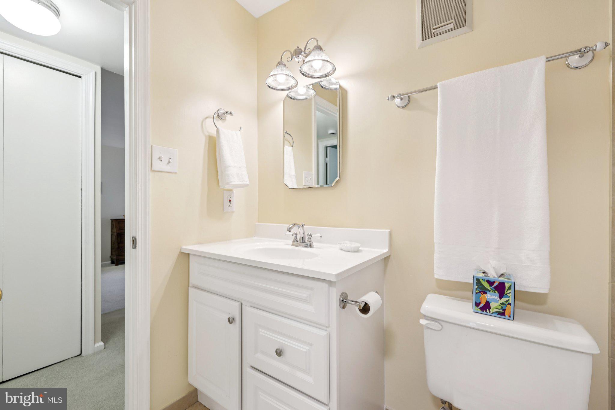 13 Pickering Court, Unit 1302 Germantown, MD 20874 - Photo 26 of 50 a bathroom with a sink vanity mirror and toilet