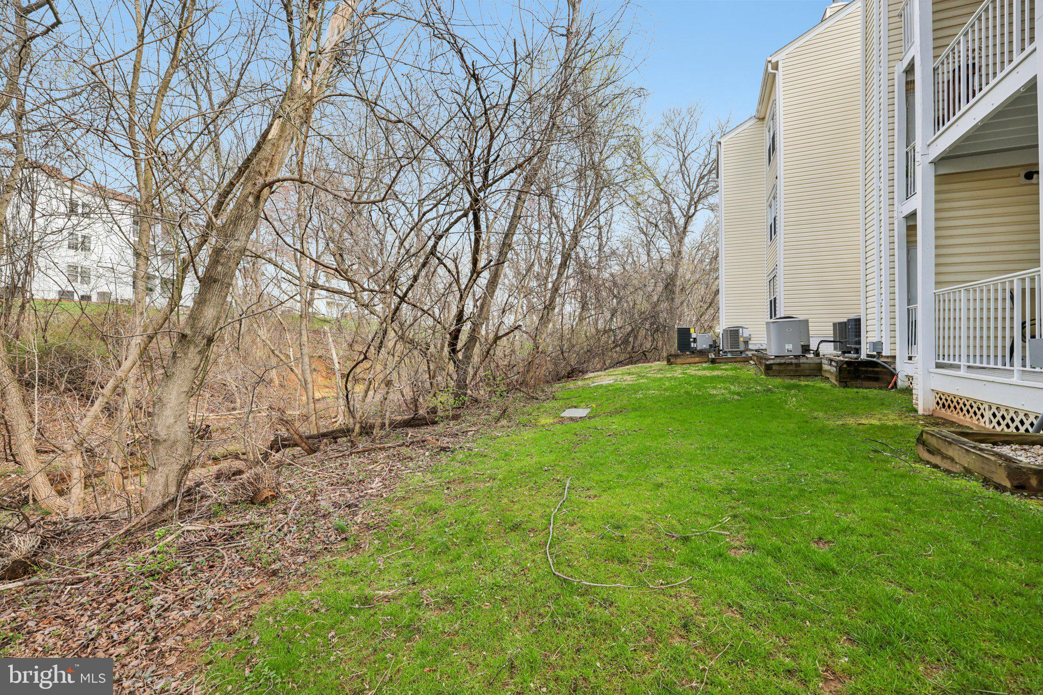 13 Pickering Court, Unit 1302 Germantown, MD 20874 - Photo 32 of 50 a backyard of a house with lots of green space