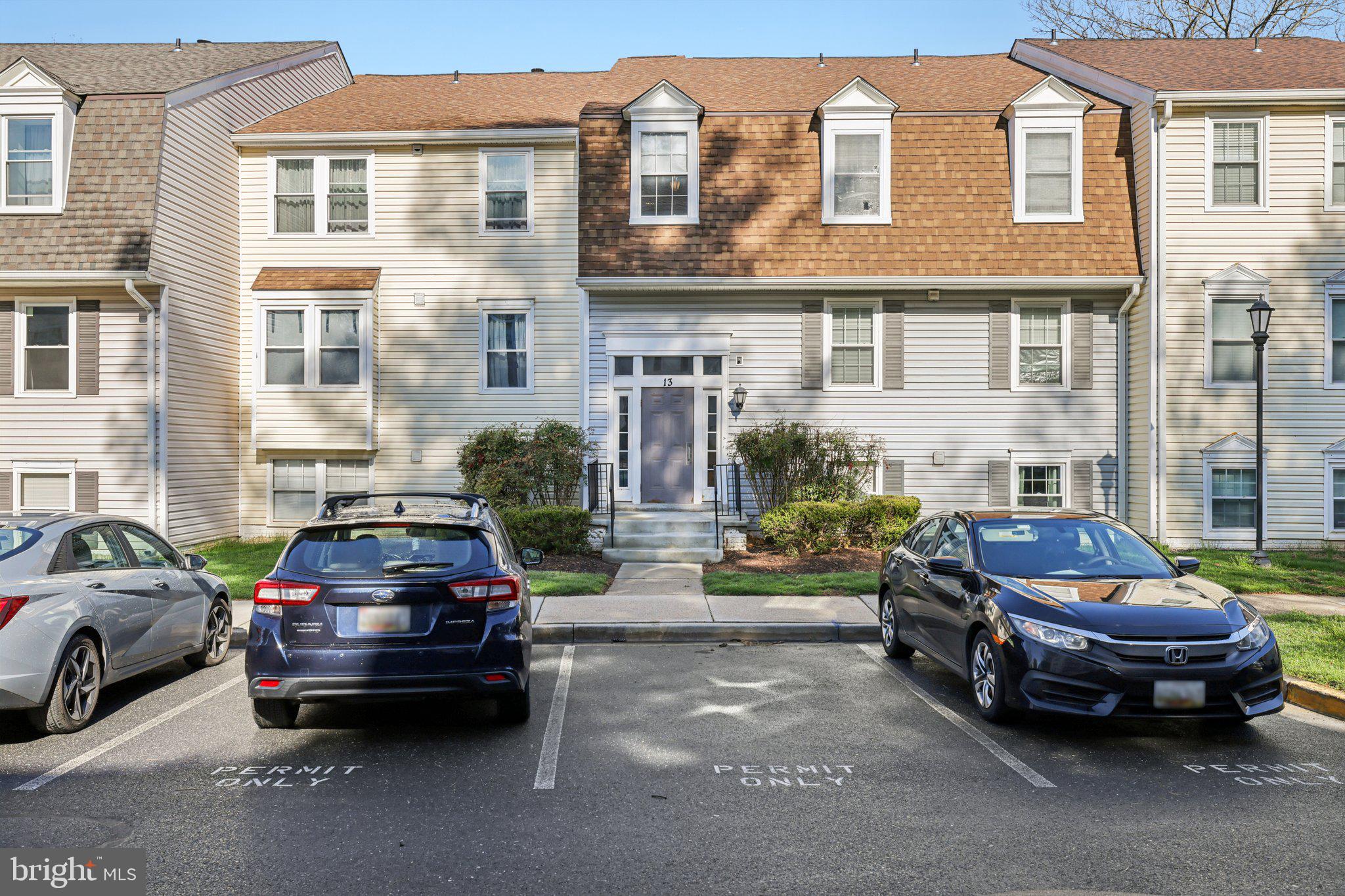 13 Pickering Court, Unit 1302 Germantown, MD 20874 - Photo 46 of 50 a car parked in front of a house