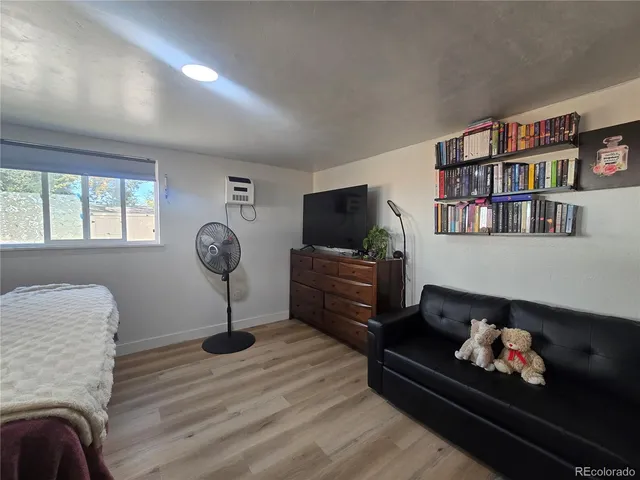a living room with furniture a window and a flat screen tv