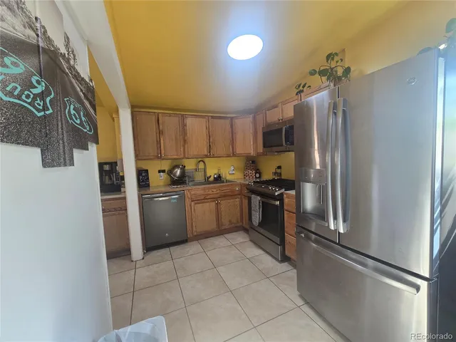 a kitchen with a refrigerator a sink and a stove