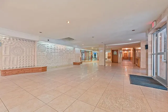a view of a room with a window and a ceiling fan