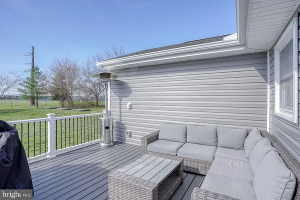 a view of a deck with chair and wooden floor