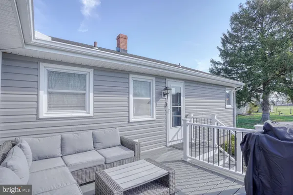 a view of a deck with couches and wooden floor