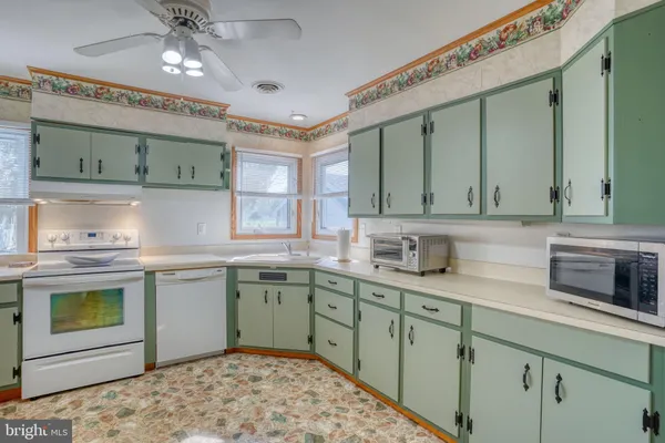a kitchen with a sink cabinets and window