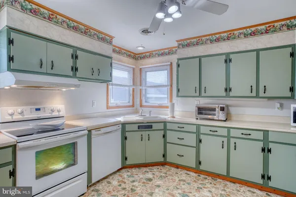 a kitchen with a sink cabinets and window