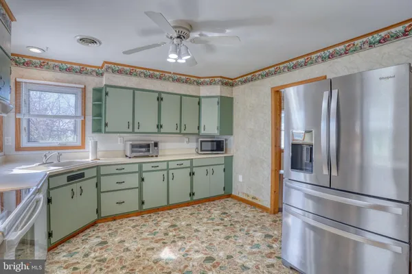 a kitchen with a refrigerator and a sink