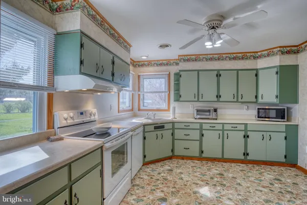 a kitchen with a sink stove and cabinets