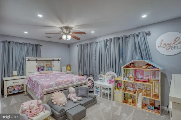a bedroom with furniture and a baby crib