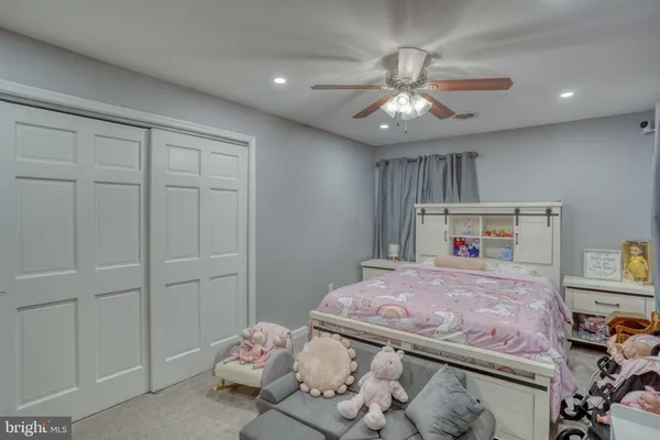 a bedroom with a bed and chandelier