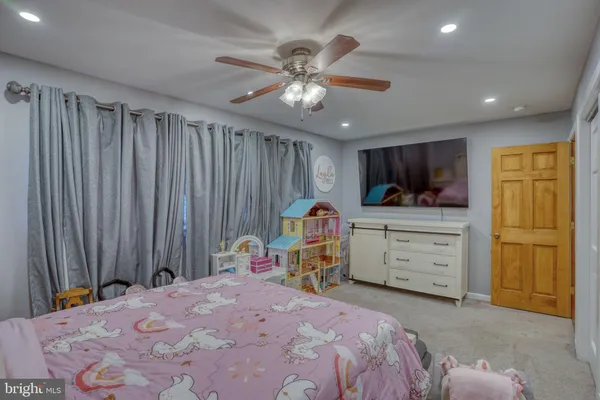 a bed room with a bed and a television
