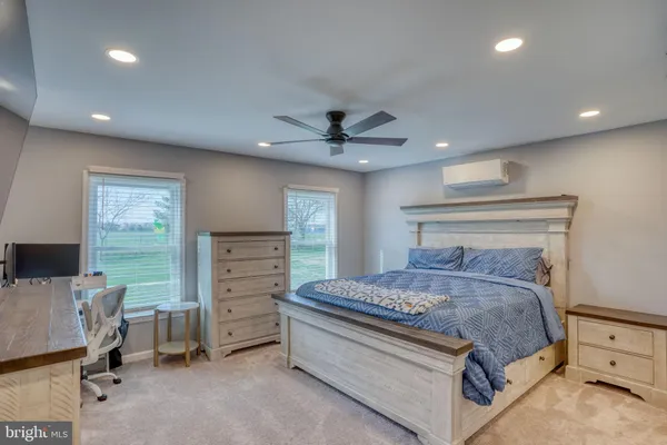 a bedroom with a bed and a desk