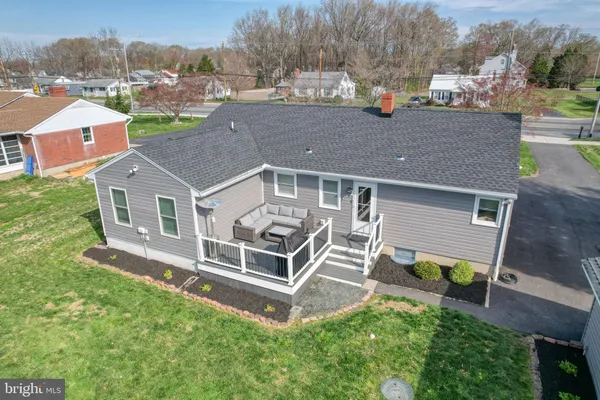 an aerial view of a house with a yard table and chairs