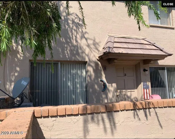 a view of a house with a wooden fence
