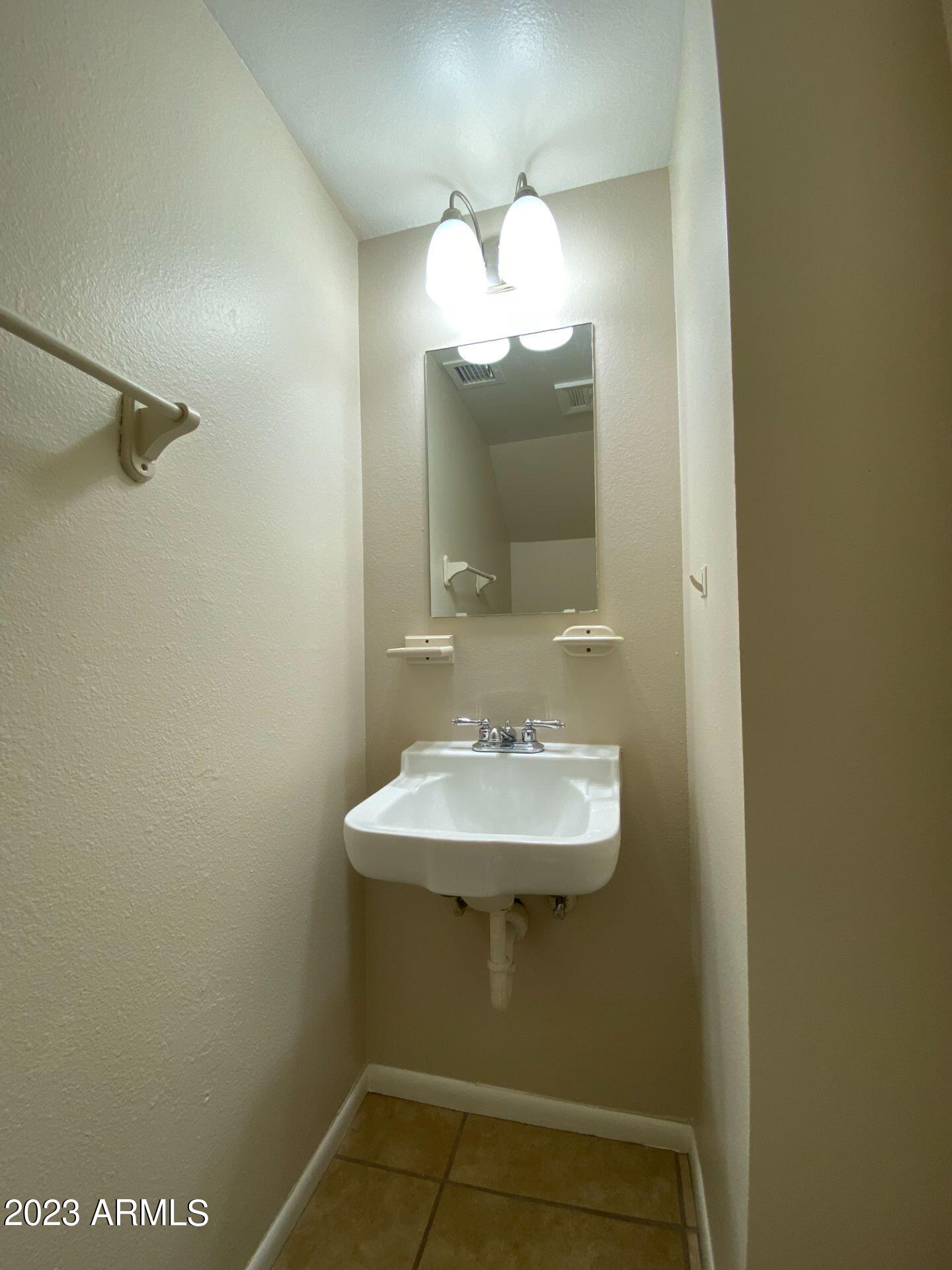 17024 East Calle Del Oro, Unit B Fountain Hills, AZ 85268 - Photo 11 of 22 a bathroom with a sink and a mirror