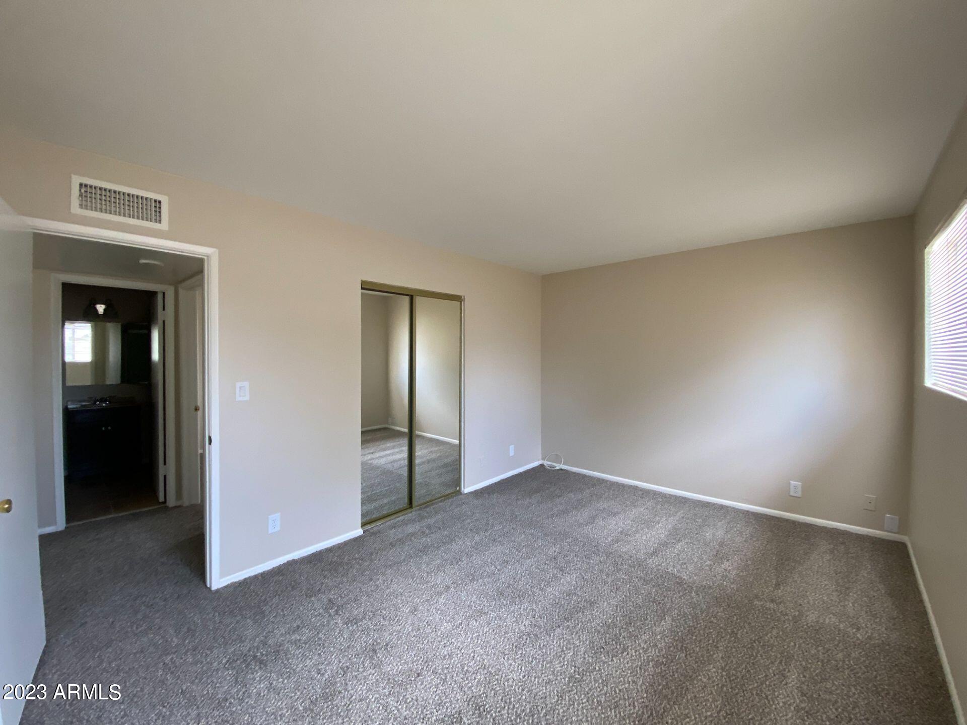 17024 East Calle Del Oro, Unit B Fountain Hills, AZ 85268 - Photo 14 of 22 an empty room with closet and windows