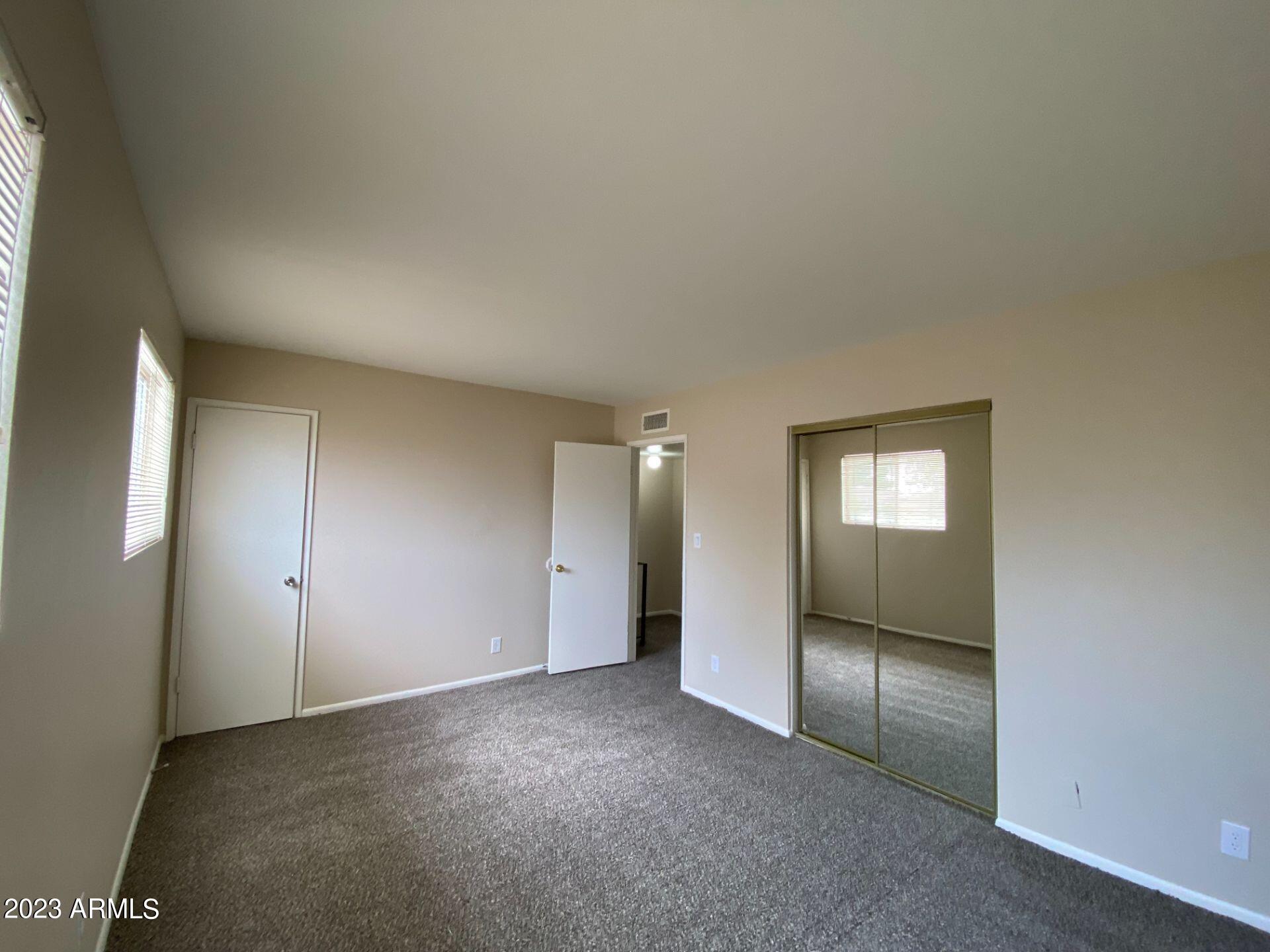17024 East Calle Del Oro, Unit B Fountain Hills, AZ 85268 - Photo 15 of 22 an empty room with closet area and windows