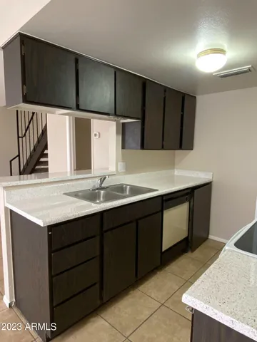 a kitchen with a sink and cabinets