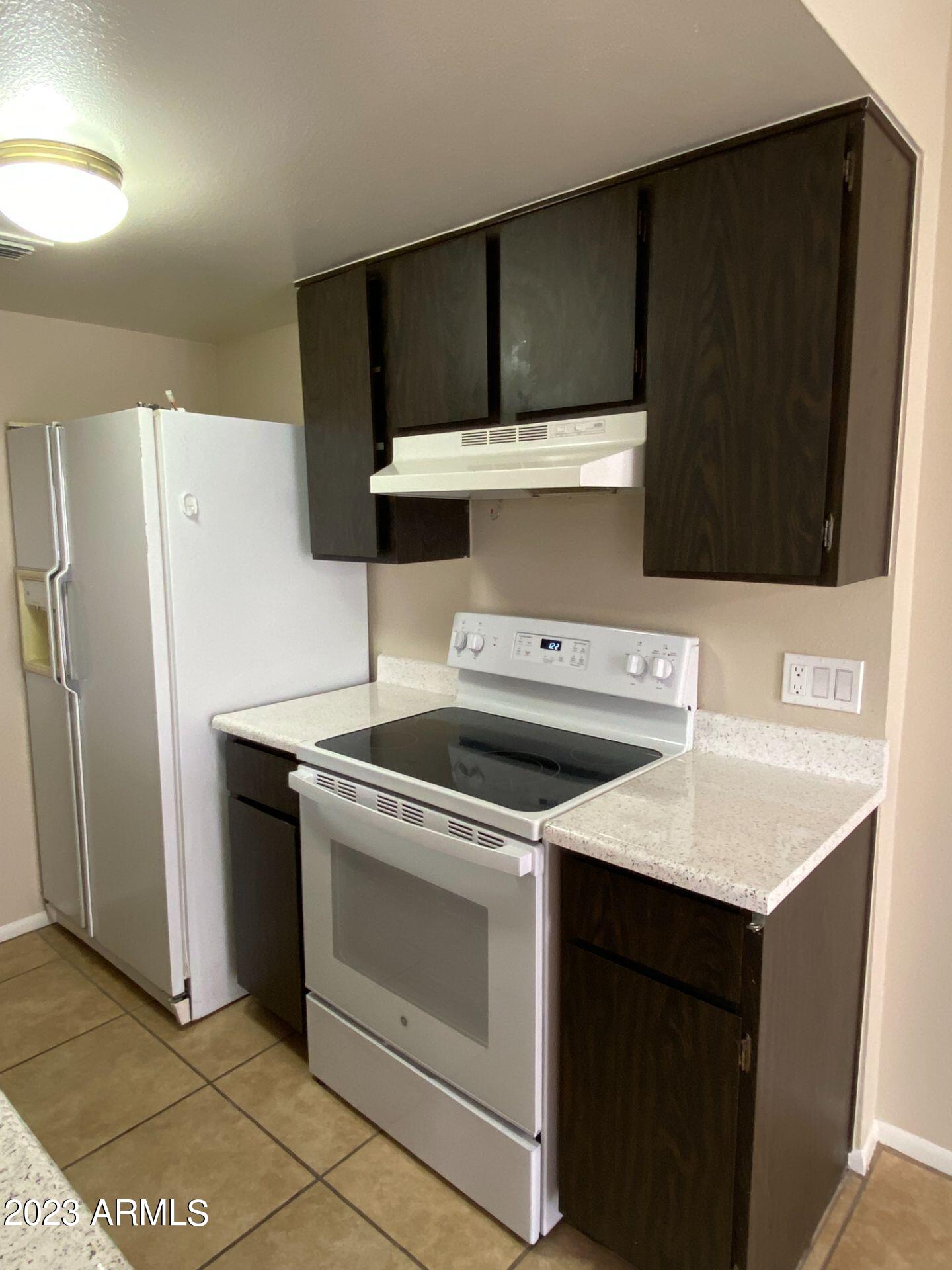 17024 East Calle Del Oro, Unit B Fountain Hills, AZ 85268 - Photo 6 of 22 a kitchen with a stove and a refrigerator