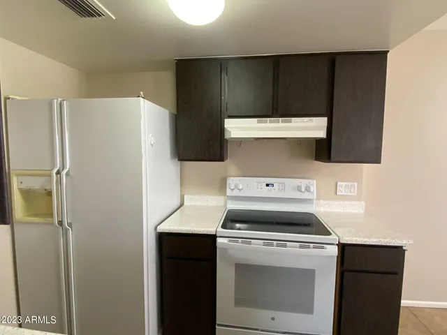 a kitchen with a stove and a refrigerator