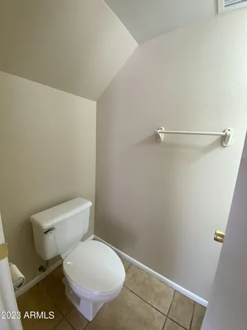 a white toilet sitting next to a shower