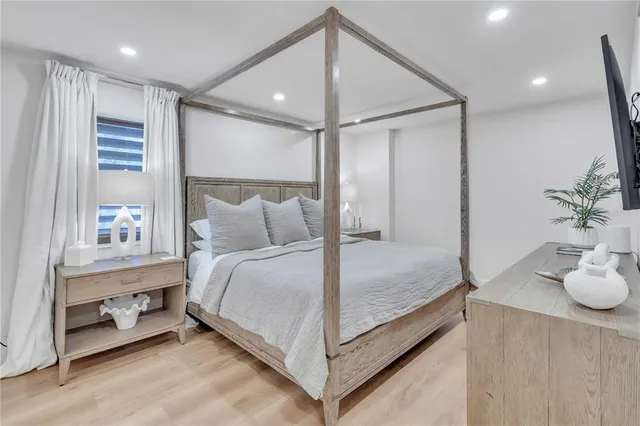 a bedroom with a bed and a potted plant