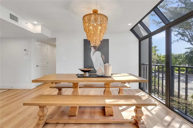 a view of a swimming pool with a table & chairs