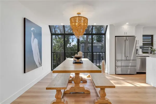 a room with pool table and a refrigerator