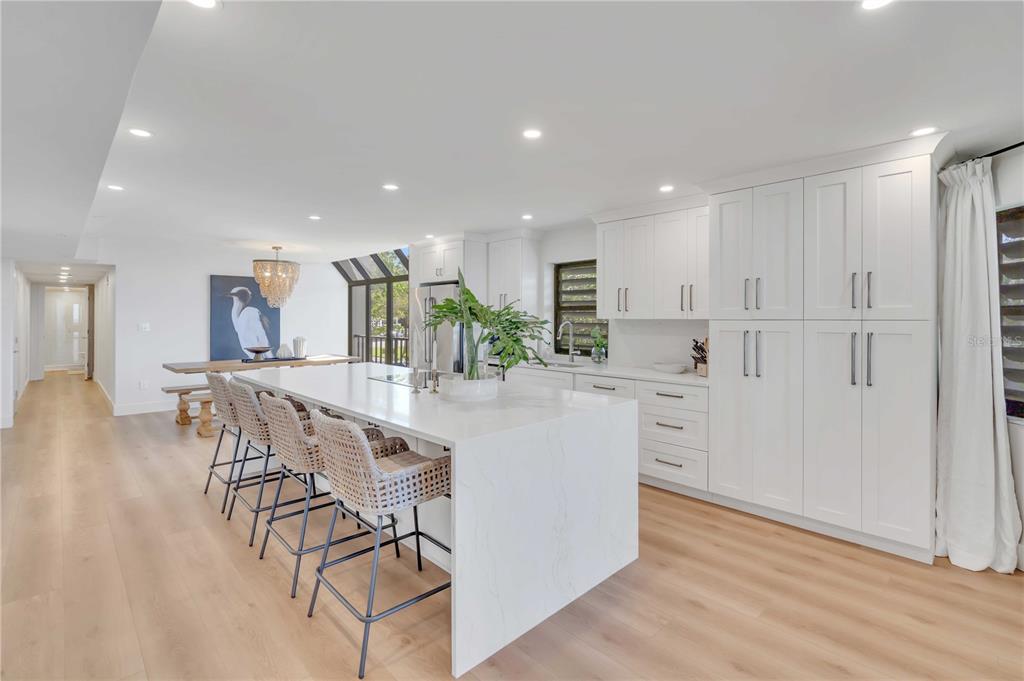 5611 Gulf Of Mexico Drive, Unit 1 Longboat Key, FL 34228 - Photo 24 of 39 a kitchen with stainless steel appliances kitchen island granite countertop a refrigerator and a stove top oven