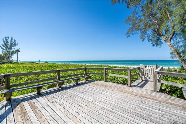 a view of a hallway with wooden floor and entryway