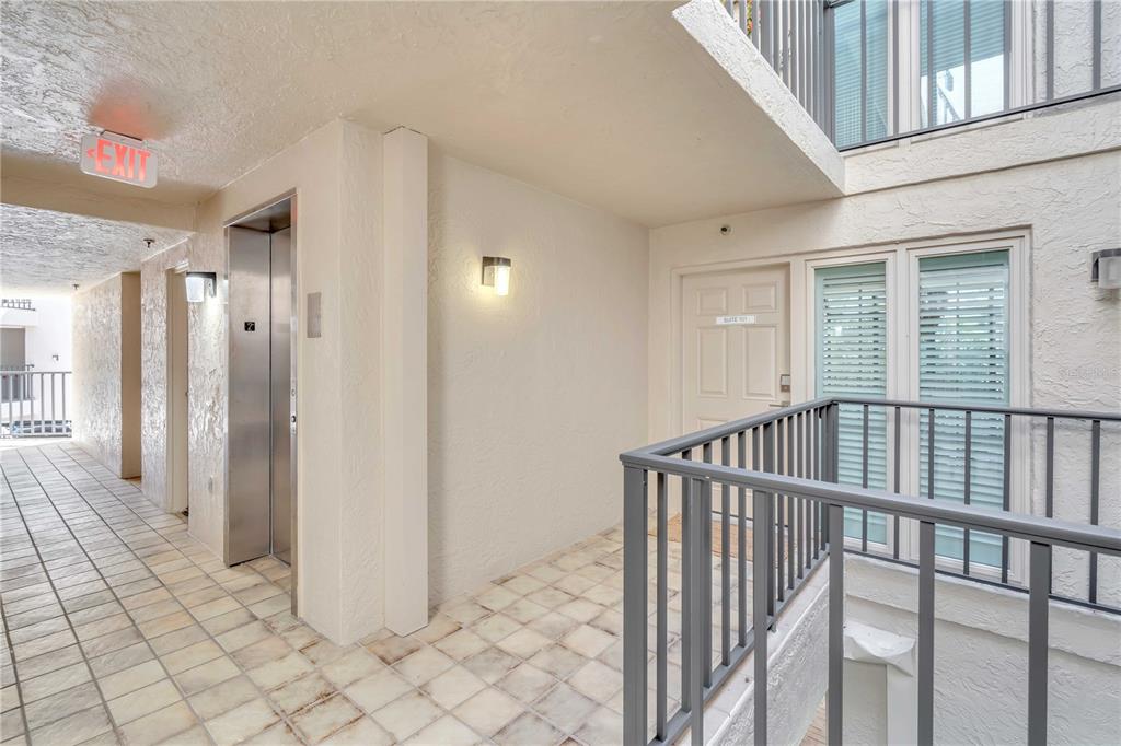 5611 Gulf Of Mexico Drive, Unit 1 Longboat Key, FL 34228 - Photo 32 of 39 a view of a hallway with wooden floor and entryway