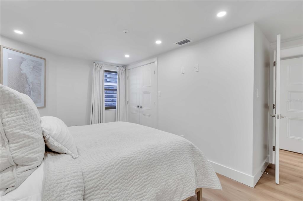 5611 Gulf Of Mexico Drive, Unit 1 Longboat Key, FL 34228 - Photo 6 of 39 a bedroom with a large bed and a closet