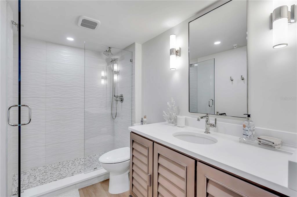 5611 Gulf Of Mexico Drive, Unit 1 Longboat Key, FL 34228 - Photo 9 of 39 a bathroom with a sink shower and a toilet
