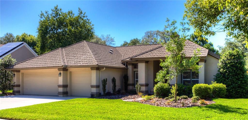 a front view of a house with a yard and porch