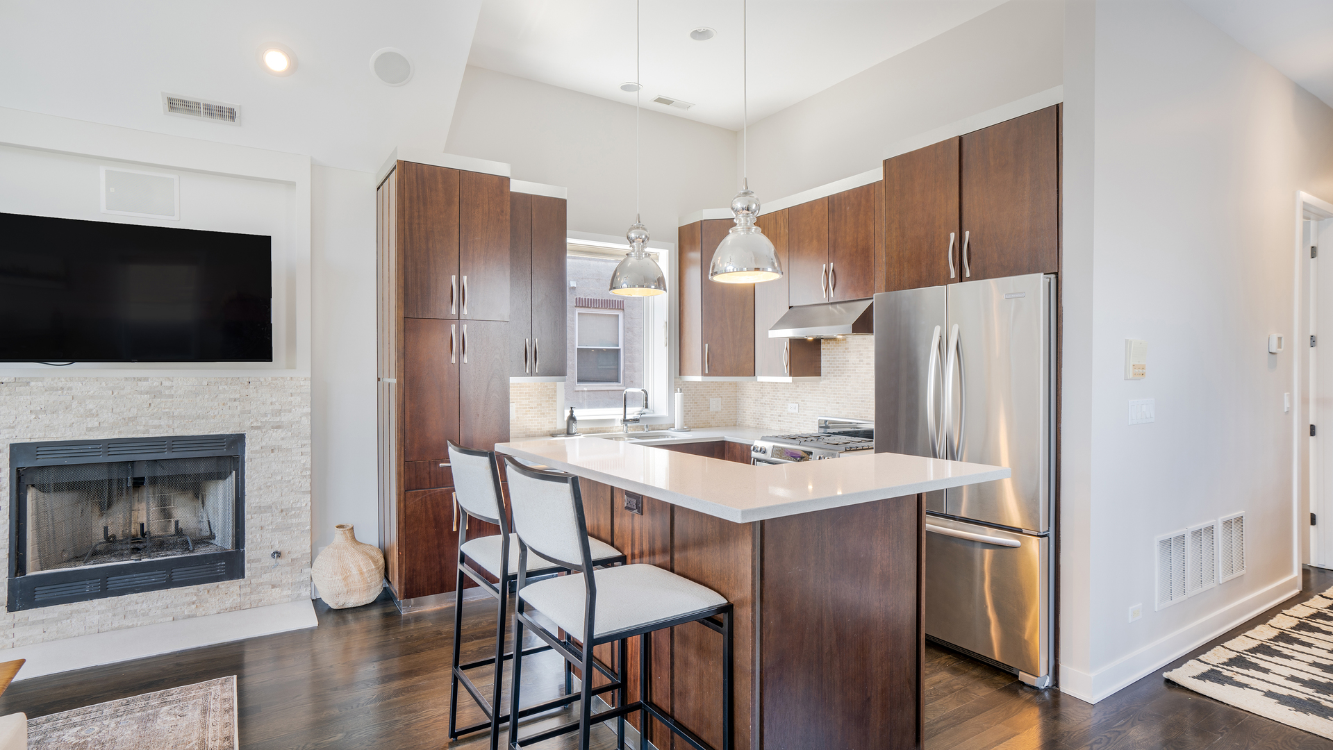 2133 West Rice Street, Unit 3 Chicago, IL 60622 - Photo 6 of 24 a kitchen with stainless steel appliances a stove a refrigerator a sink with wooden floor and cabinets