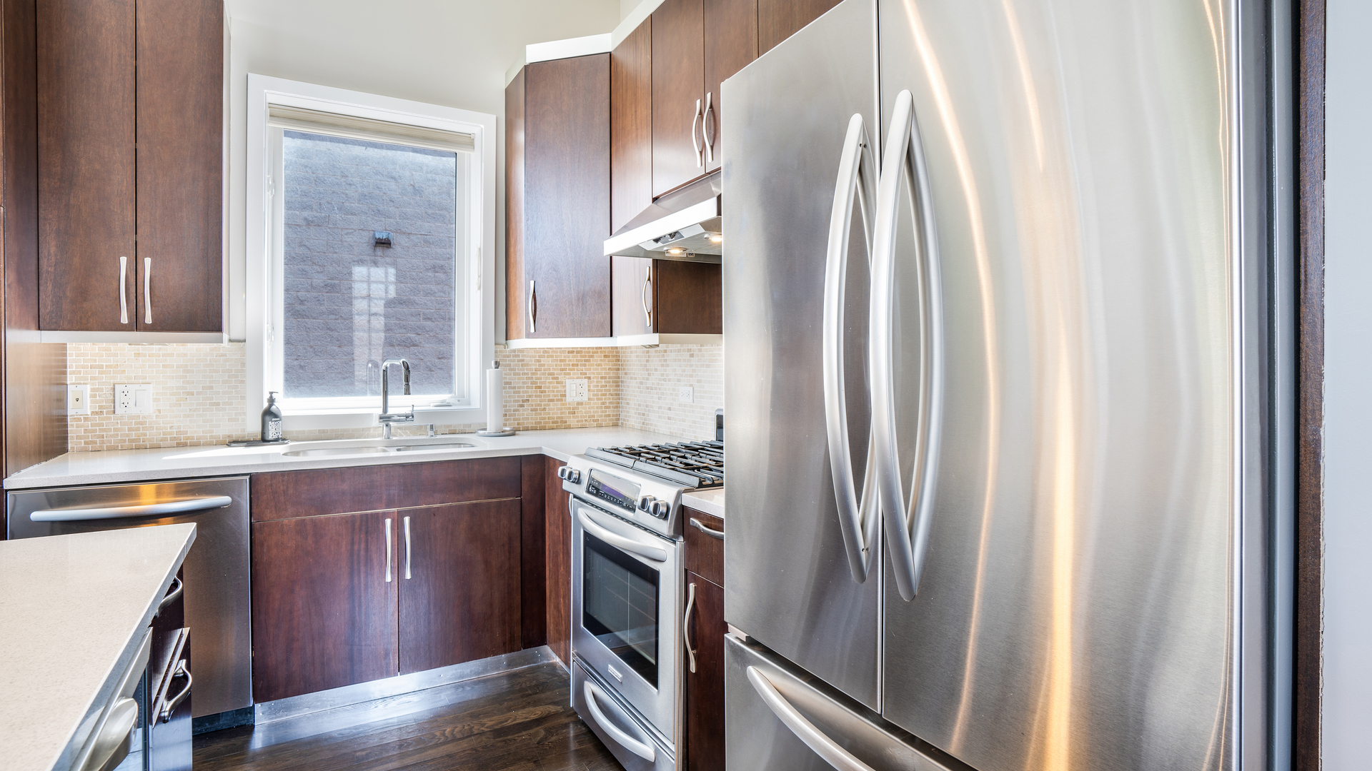 2133 West Rice Street, Unit 3 Chicago, IL 60622 - Photo 7 of 24 a kitchen with stainless steel appliances granite countertop a refrigerator and a sink