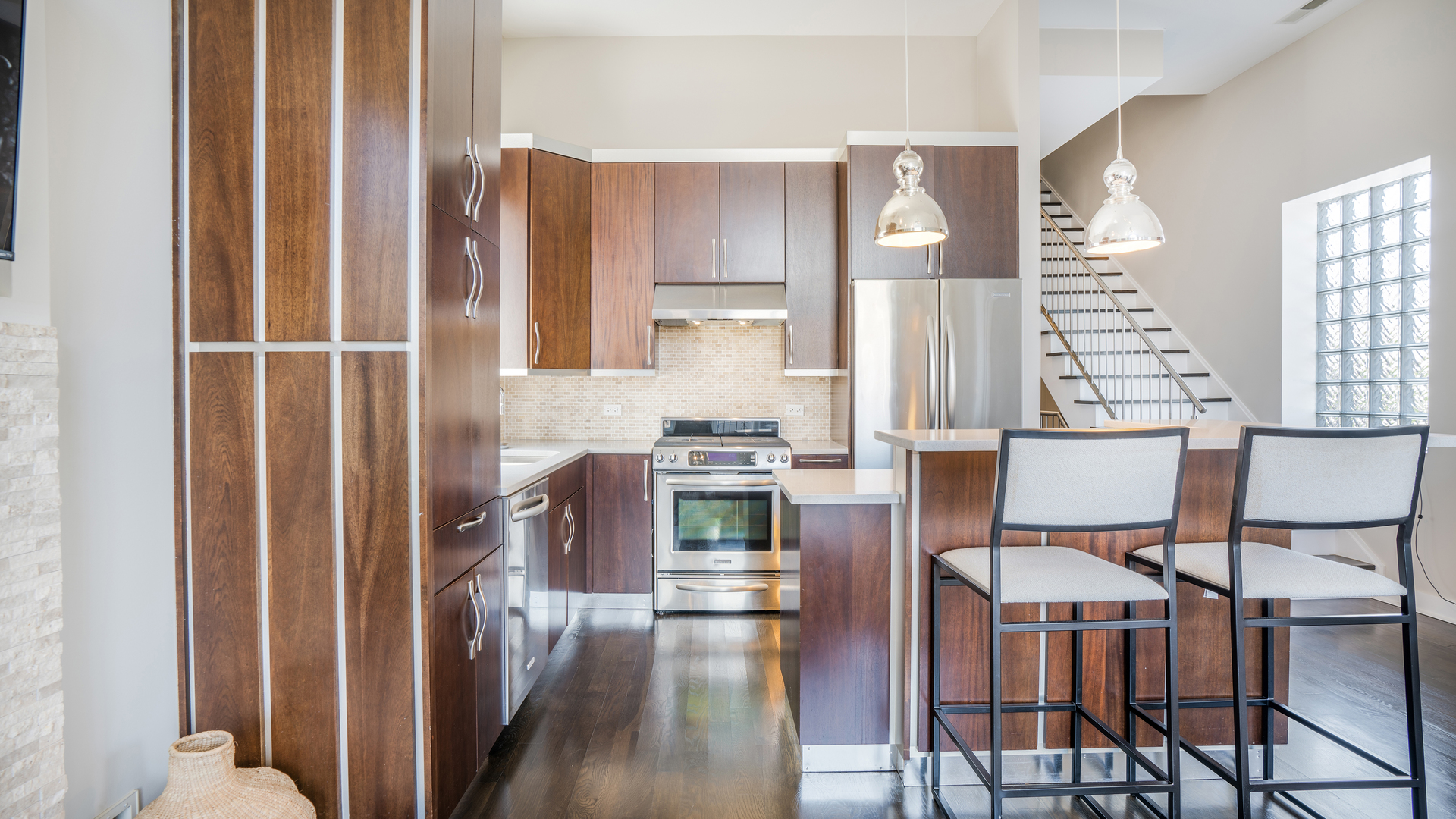 2133 West Rice Street, Unit 3 Chicago, IL 60622 - Photo 8 of 24 a kitchen with stainless steel appliances granite countertop a stove and a refrigerator