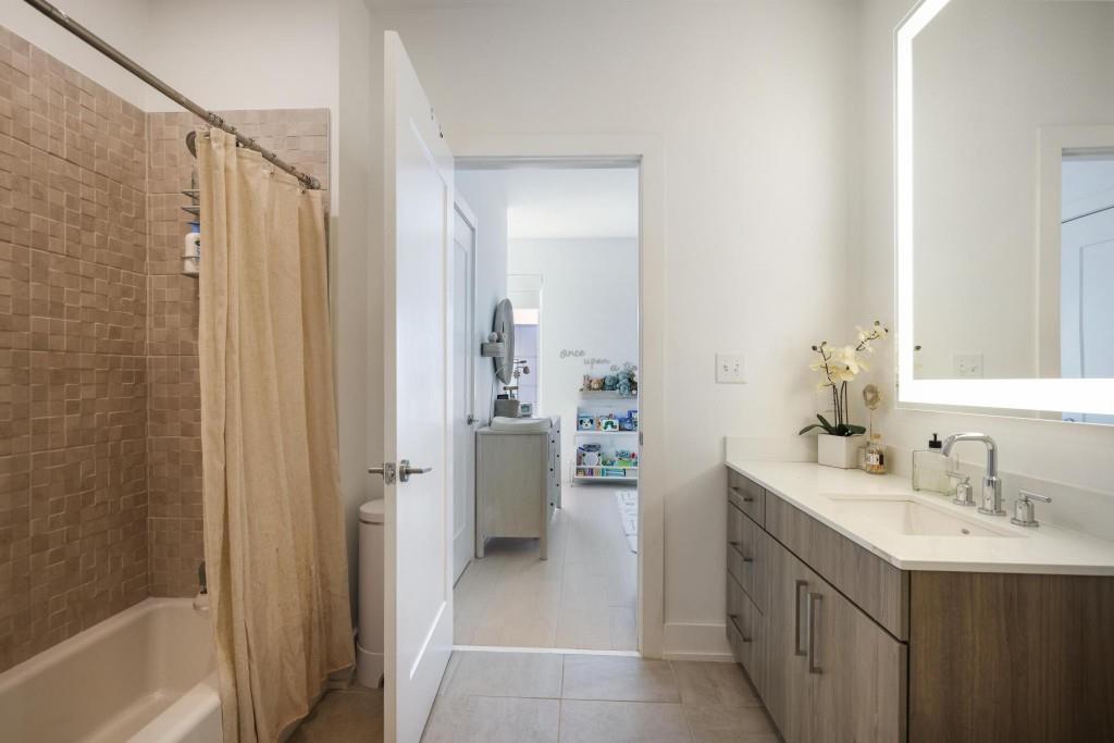 775 Juniper Street Northeast, Unit 602 Atlanta, GA 30308 - Photo 21 of 40 a bathroom with a sink a toilet and shower