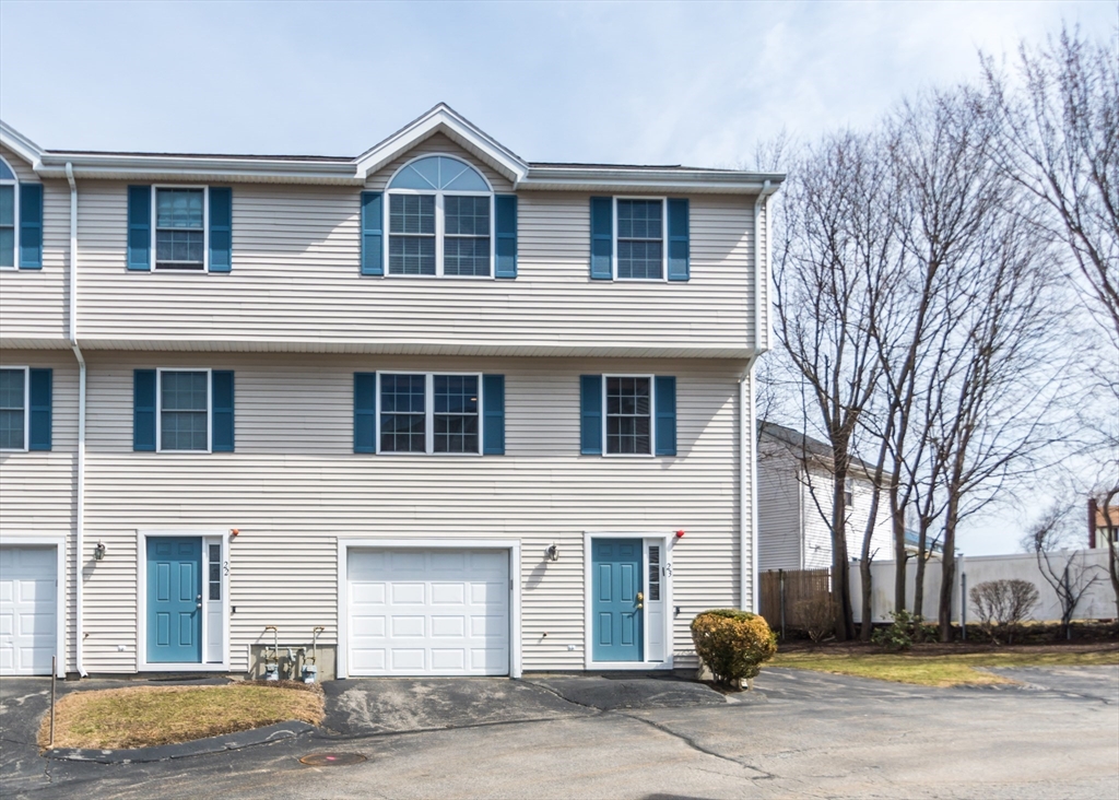 985 Trapelo Road, Unit 23 Waltham, MA 02452 - Photo 3 of 27 a front view of a house with a yard