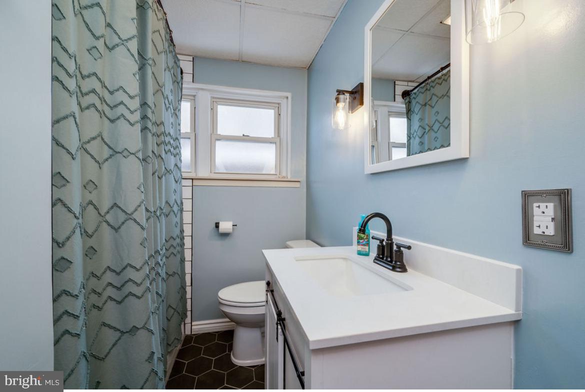 2054 Cleveland Avenue Reading, PA 19609 - Photo 16 of 27 a bathroom with a sink toilet and a mirror