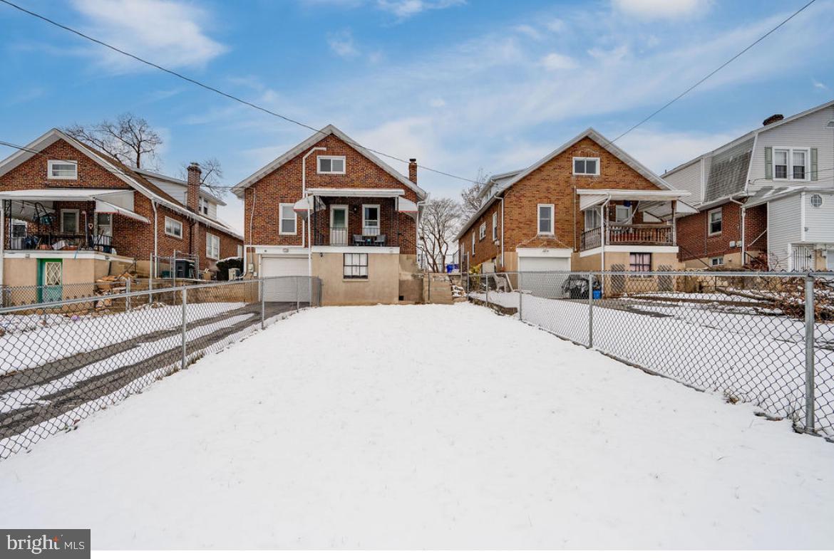 2054 Cleveland Avenue Reading, PA 19609 - Photo 27 of 27 a front view of a house with a yard covered in snow