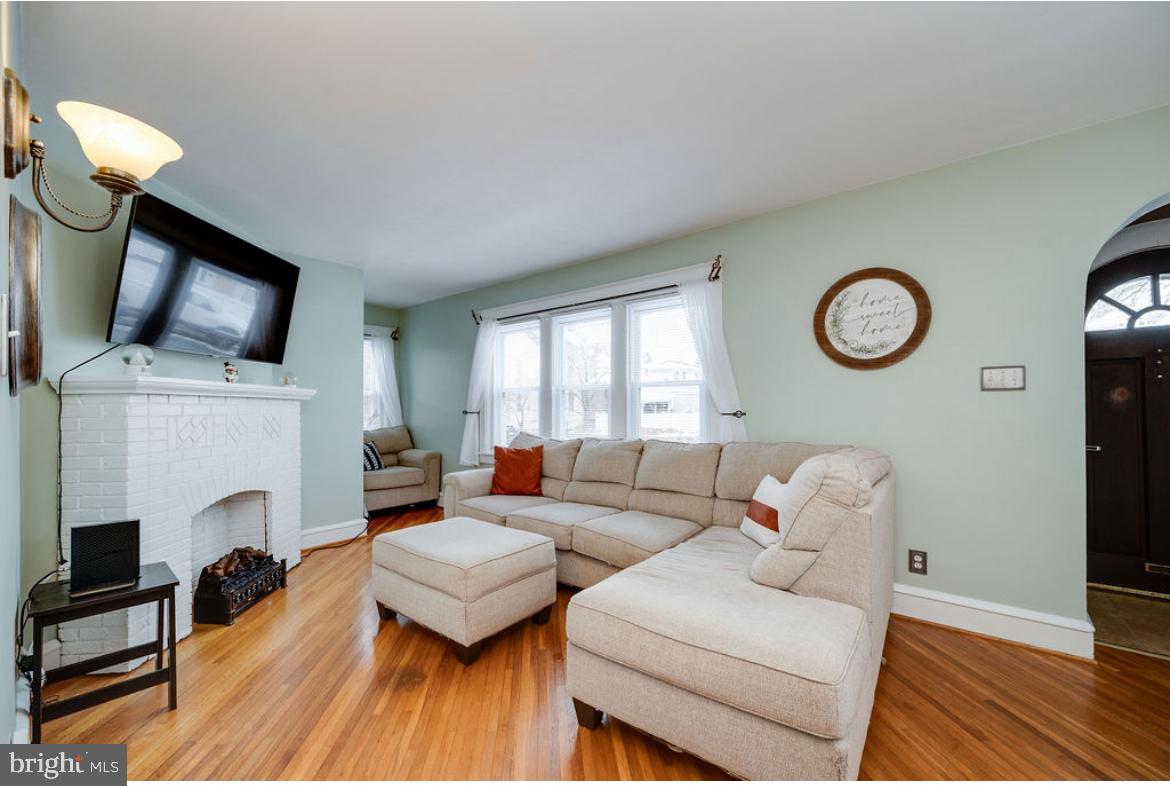 2054 Cleveland Avenue Reading, PA 19609 - Photo 7 of 27 a living room with furniture a fireplace and a flat screen tv