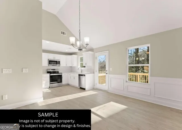 a view of a kitchen with granite countertop a stove top oven