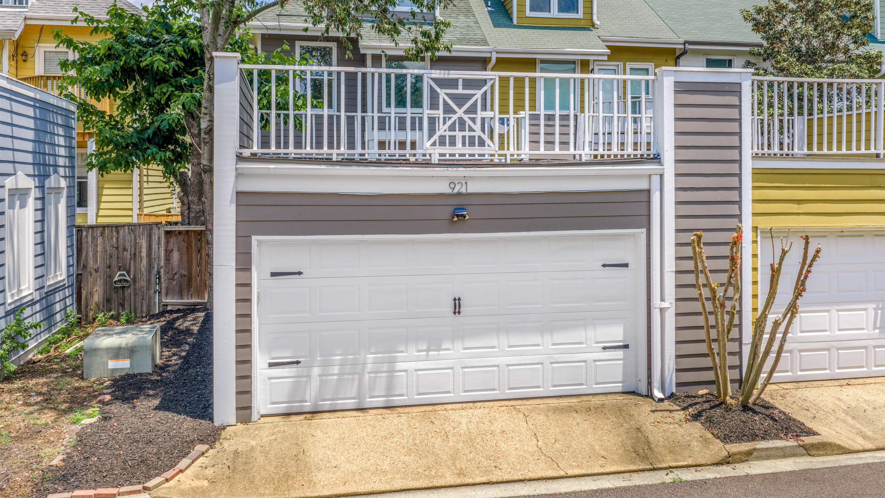 921 Harbor View Drive Memphis, TN 38103 - Photo 33 of 33 Attached garage with a white panel door, featuring decorative hardware and an overhead light fixture