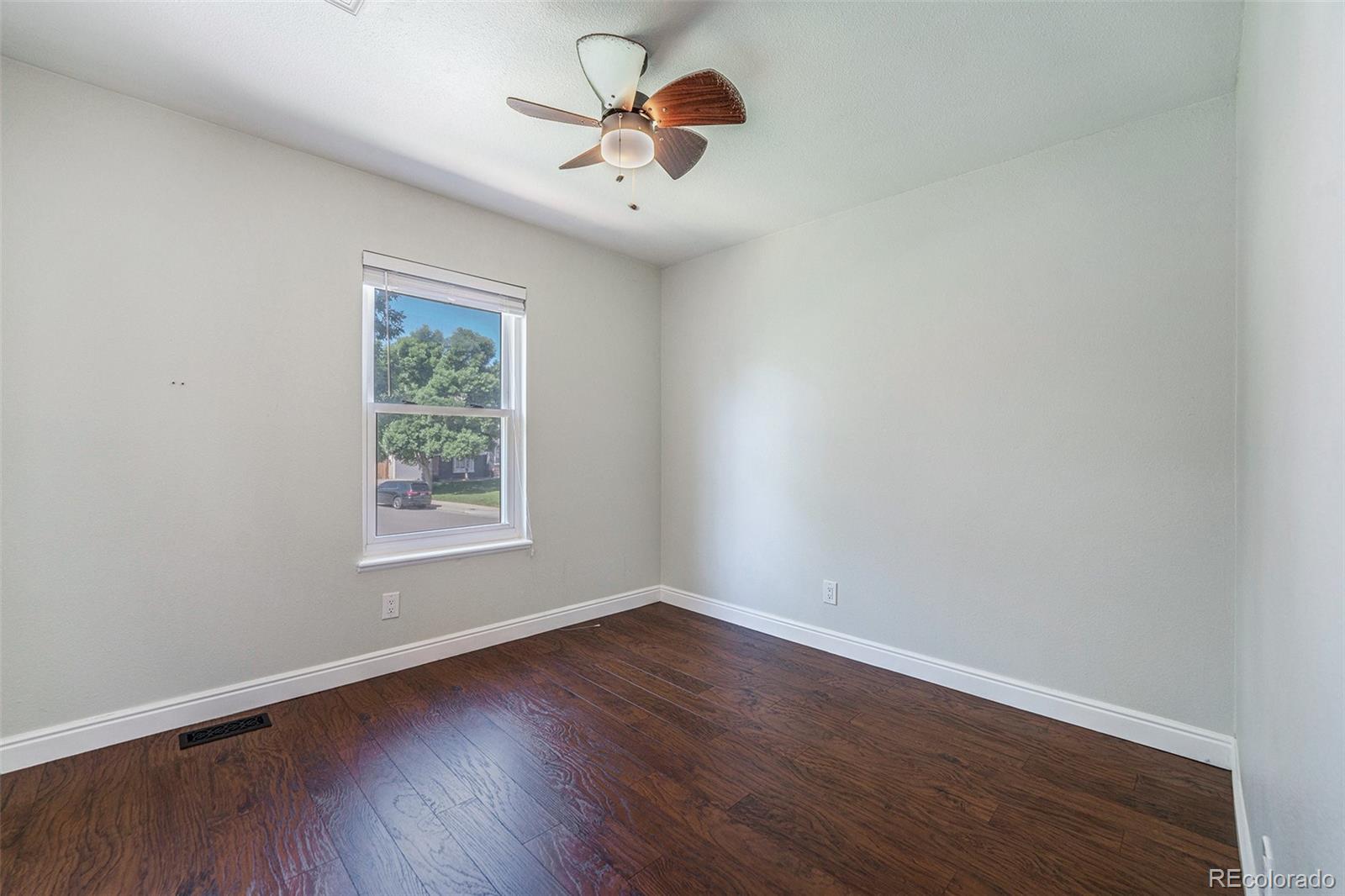 9897 Independence Street Westminster, CO 80021 - Photo 17 of 29 wooden floor in an empty room with a window