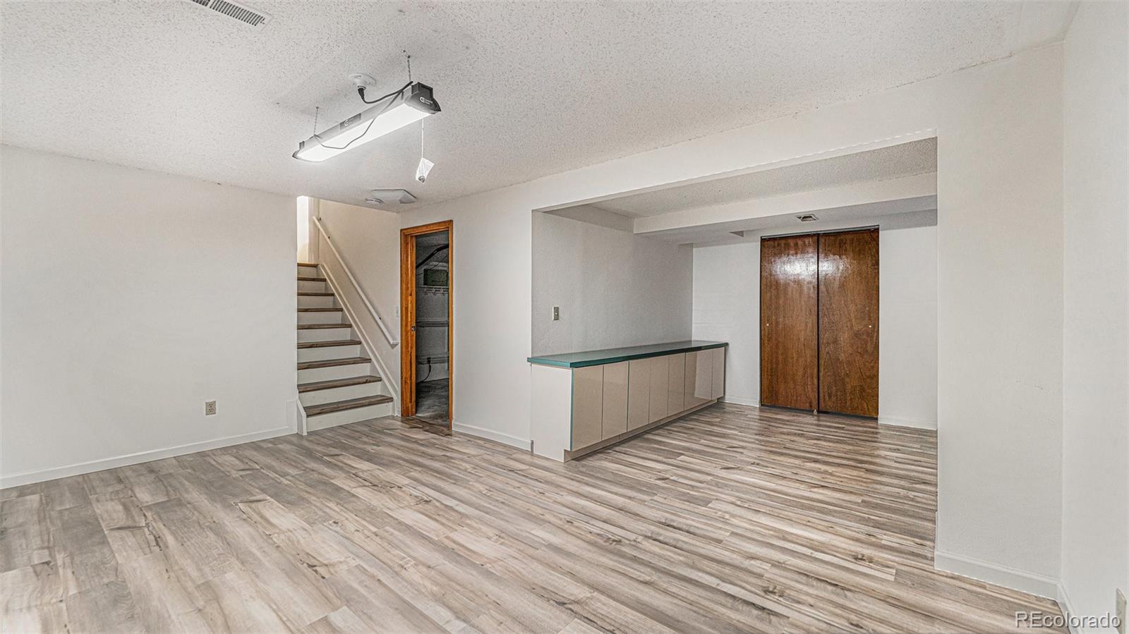 9897 Independence Street Westminster, CO 80021 - Photo 20 of 29 a view of a livingroom with wooden floor and stairs