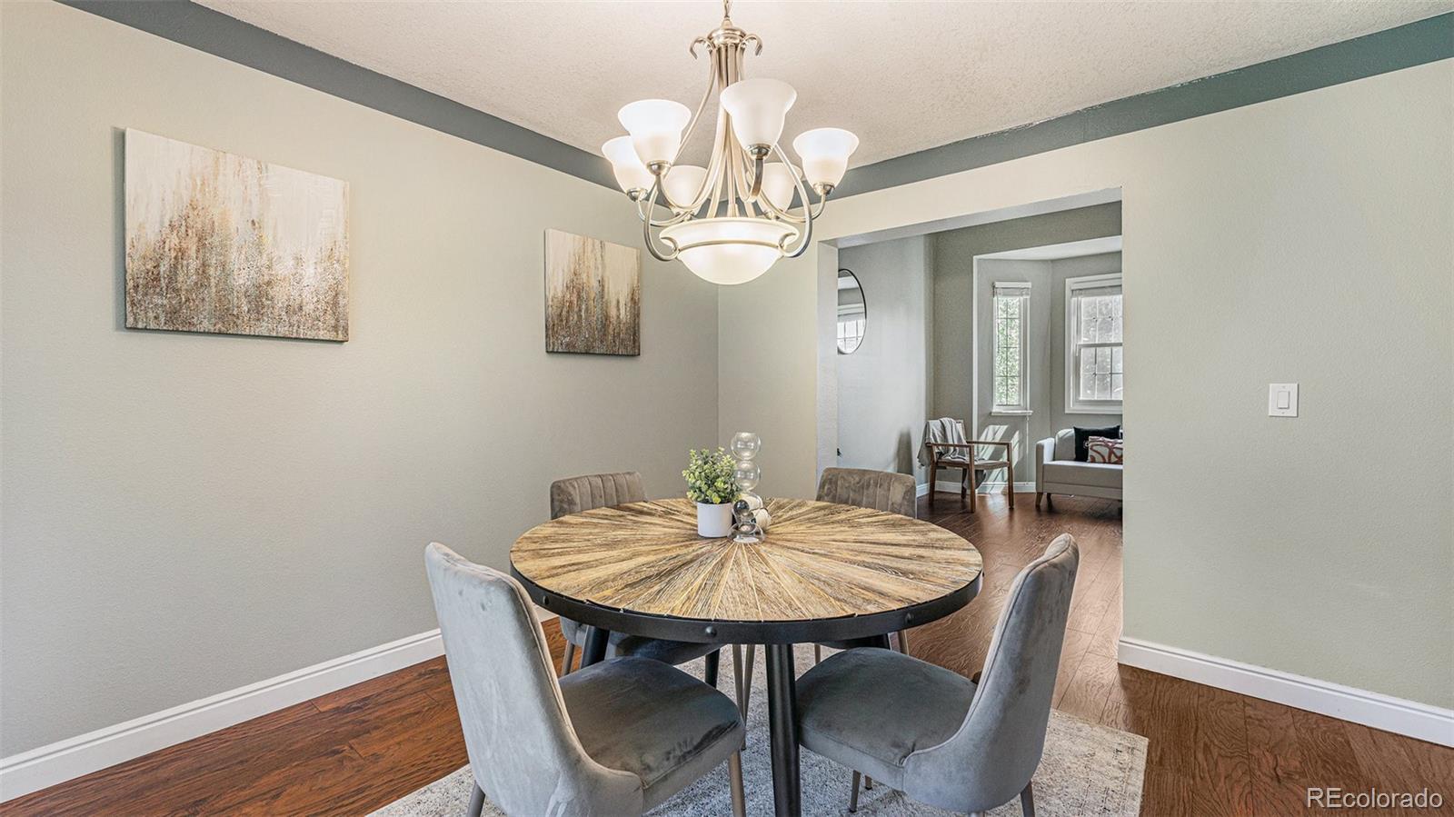 9897 Independence Street Westminster, CO 80021 - Photo 6 of 29 a view of a dining room with furniture and wooden floor