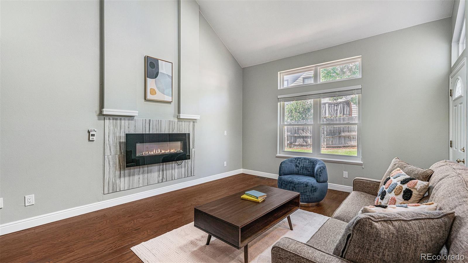 9897 Independence Street Westminster, CO 80021 - Photo 10 of 29 a living room with furniture and a fireplace