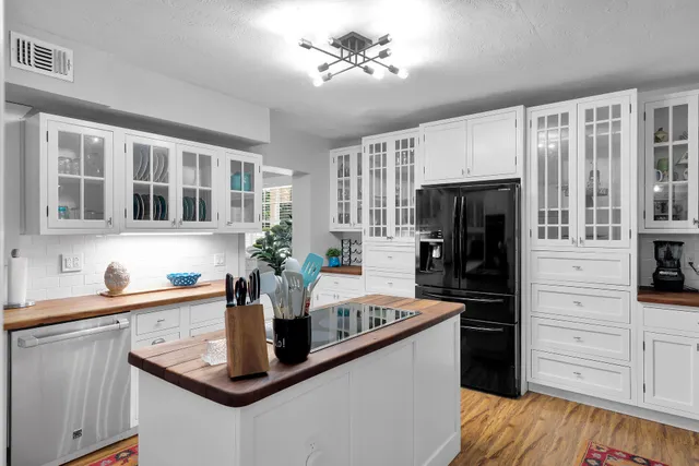 a kitchen with a refrigerator and a sink